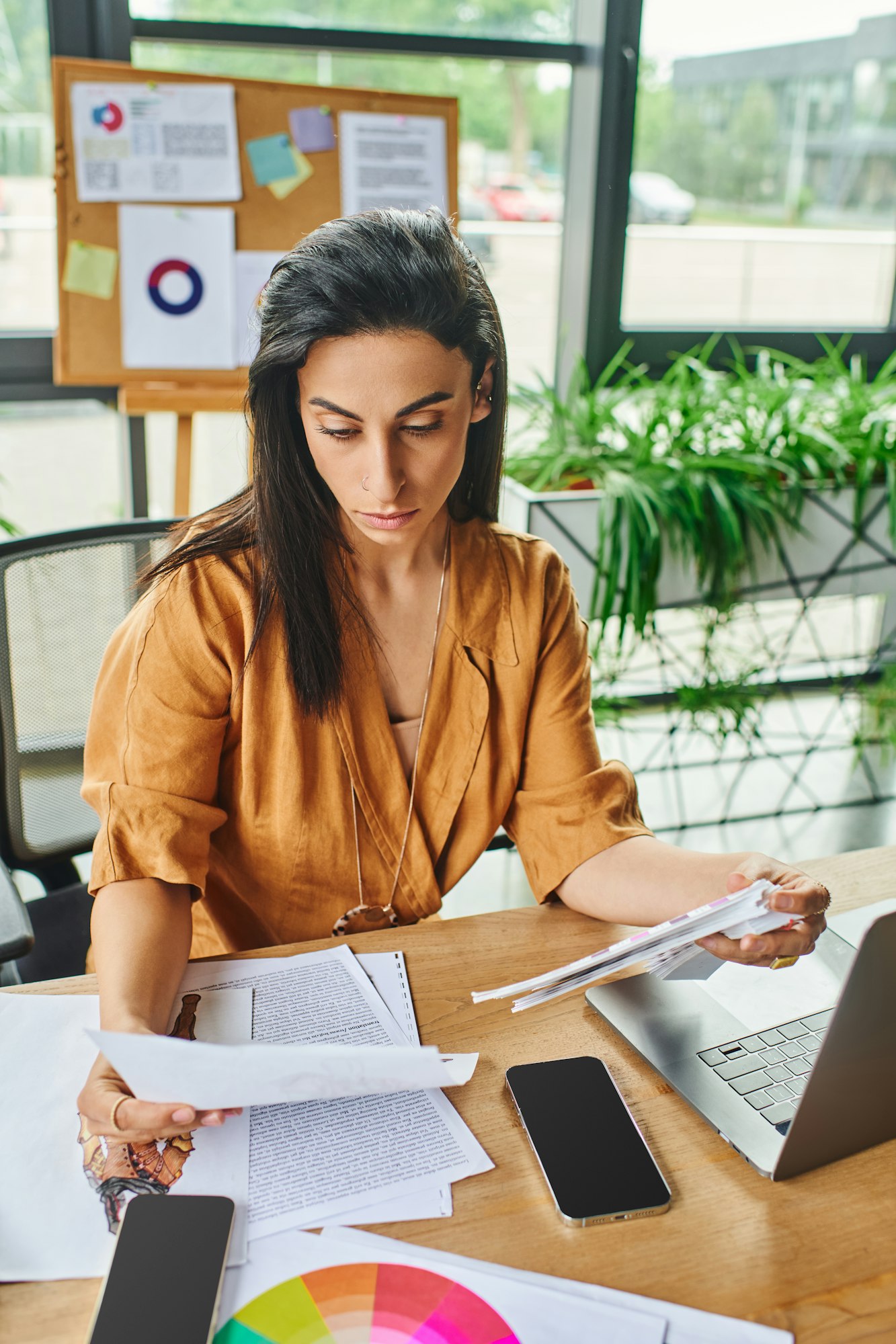 Middle eastern woman reviews documents in office